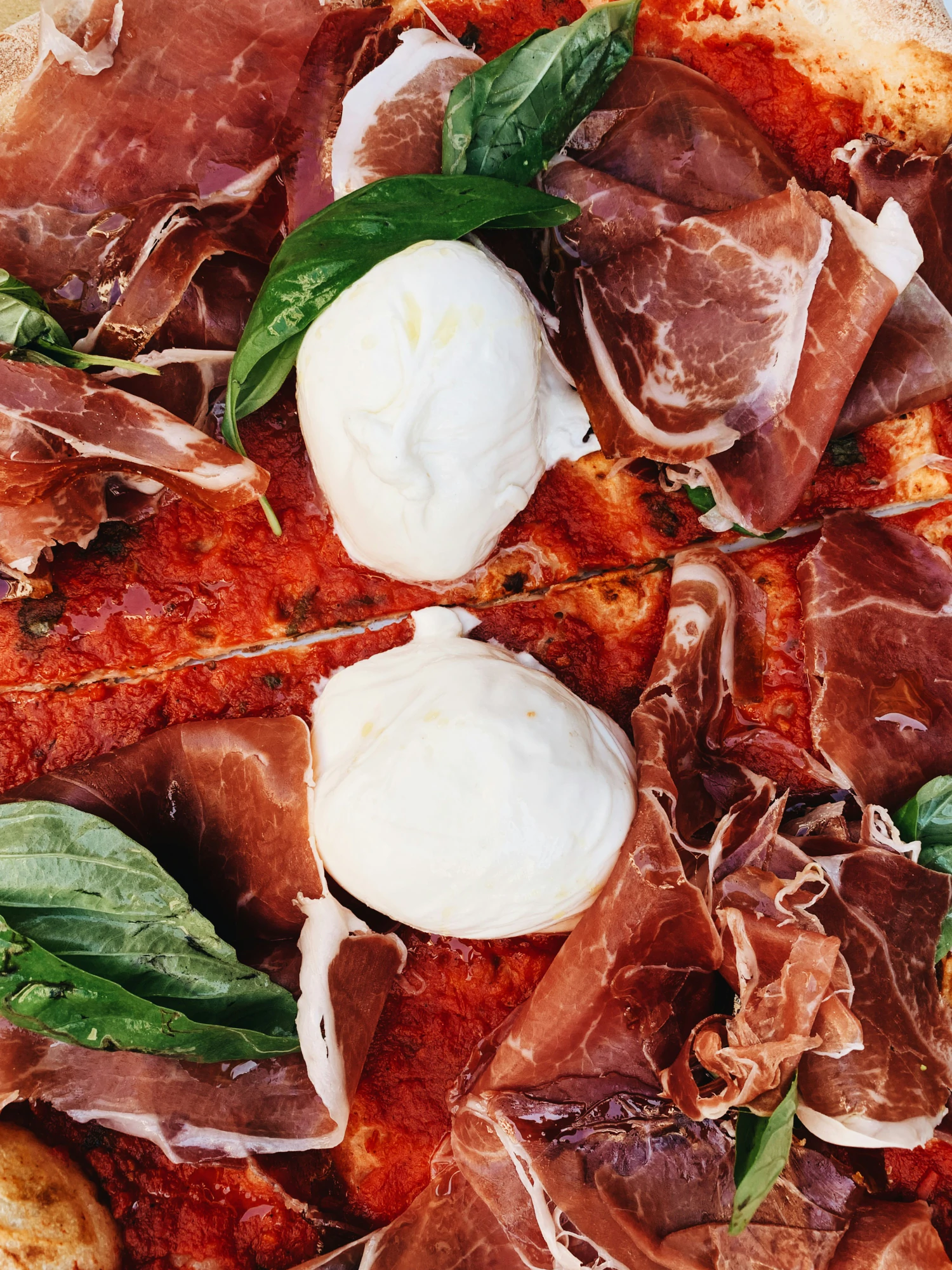 Prosciutto pizza with fresh cheese and basil